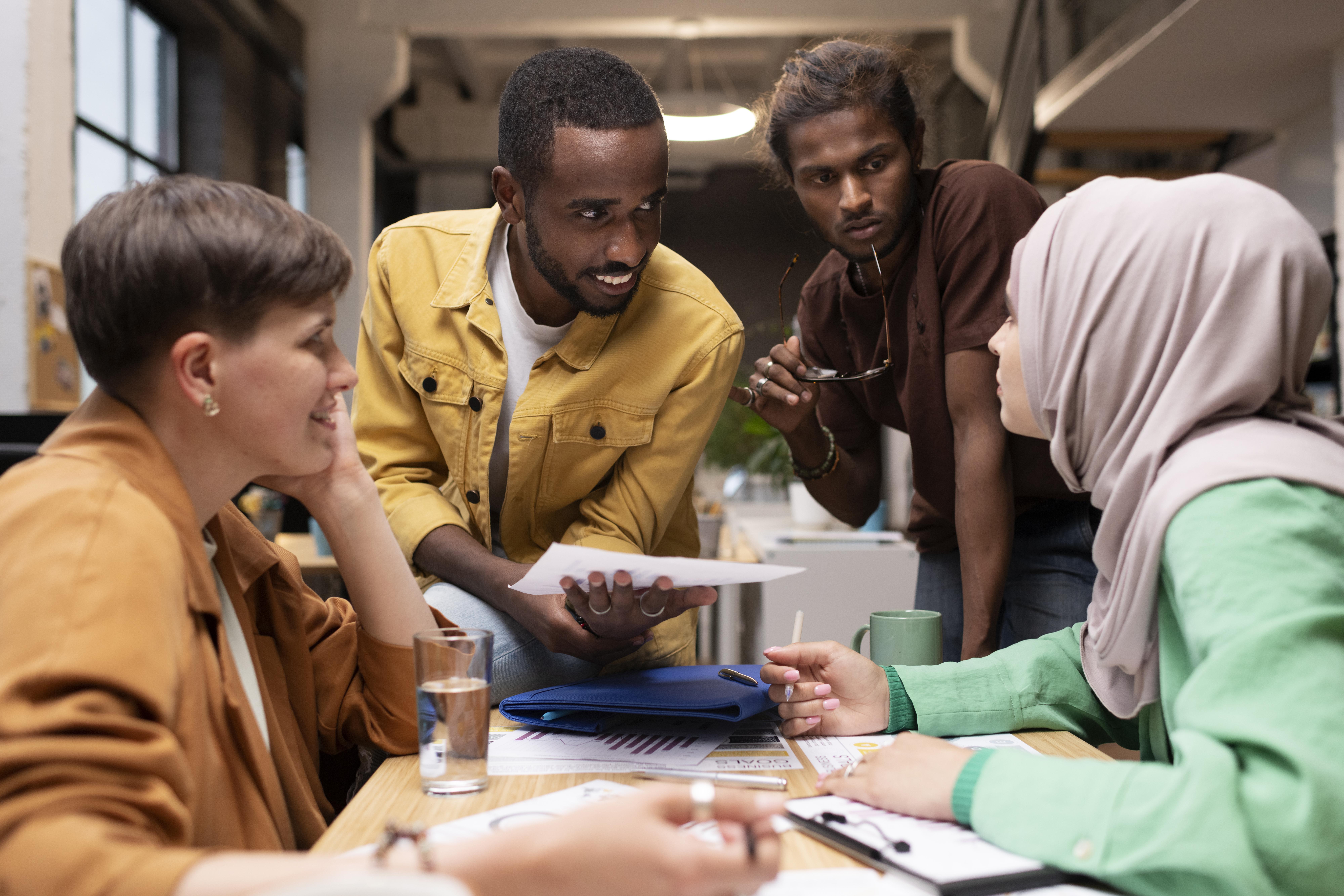 medium-shot-colleagues-discussing-table